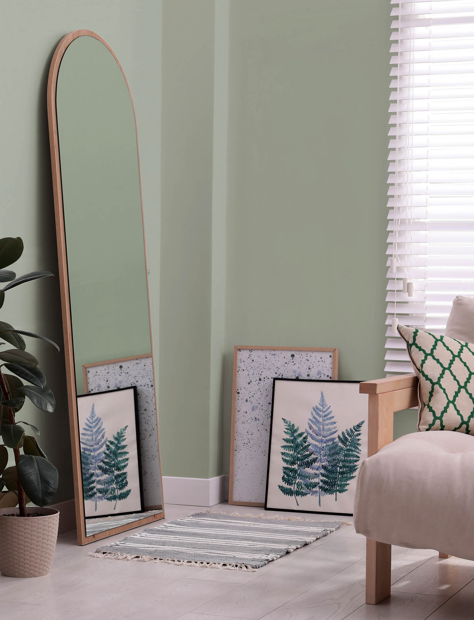 Beautiful mirror, furniture and plant in living room. Interior design